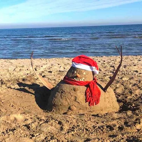 Sand snowman on the beach