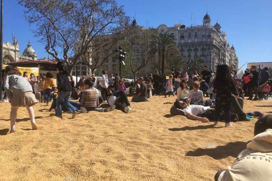 Rice on city square, people, buildings at event